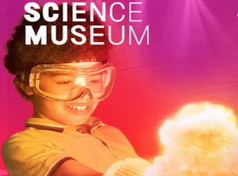 A red and purple poster with a picture of a young boy wearing goggles and holding an object in flames.