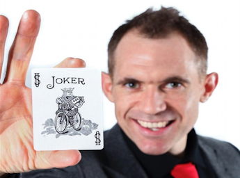 A picture of Magic Martin holding a Joker card.
