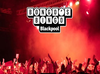 A picture of a crowd holding bingo cards.