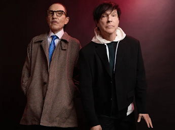 A darkpurple poster with the darwing of a man and woman dressed with the union flag,