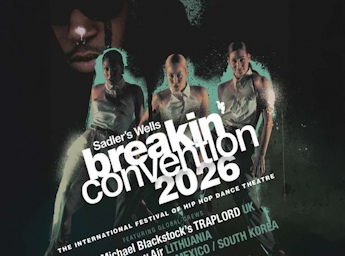 A picture of three dancing women and a black rapper in the background. 