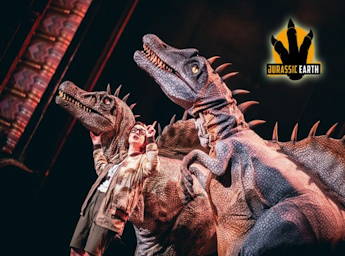 A picture of two dinosaurs and a ranger in stage.