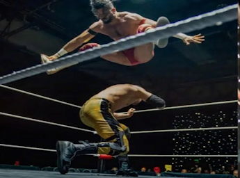 A picture of two wrestlers fighting on a ring.