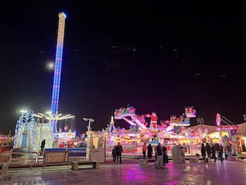 Comedy station room packed with people and a comedian on stage.