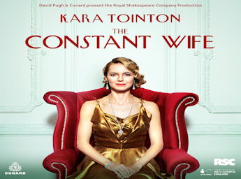 Picture of a woman in a golden dress seated in a large red chairs.