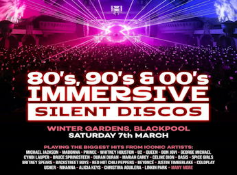 A picture of a party with hundreds of people and pink laser lights.