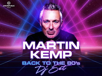 A picture of Martin Kemp and laser lights behind him.