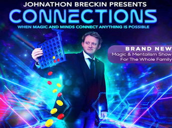 A picture of Johnathon Breckin holding a connect four game.